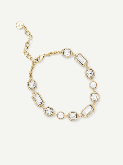 Gold bracelet with clear gemstones on a white background