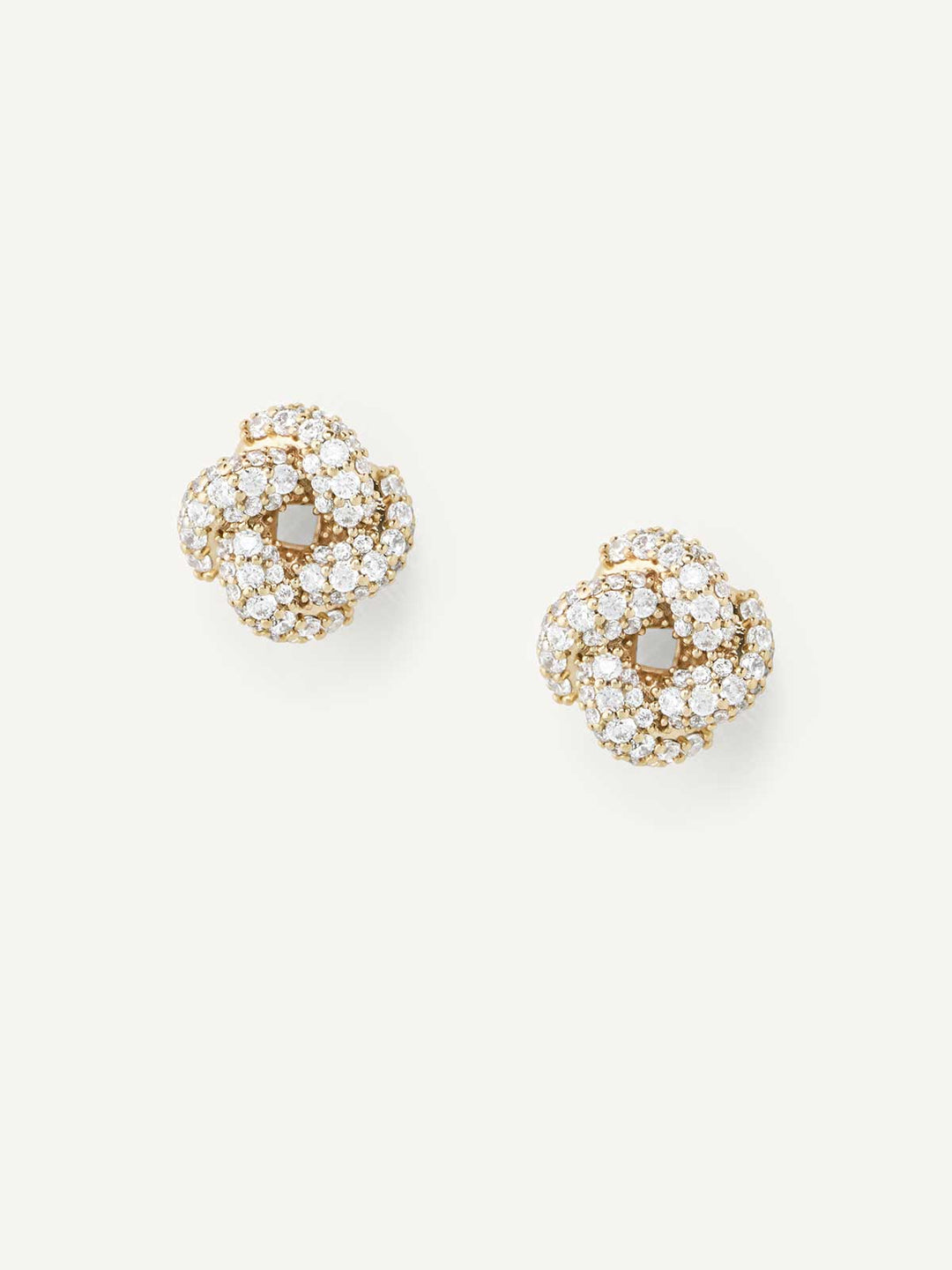 Gold earrings with clear gemstones on a white background