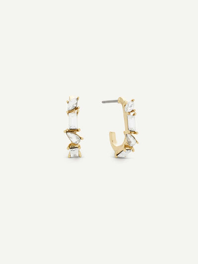 Gold and crystal hoop earrings on a white background
