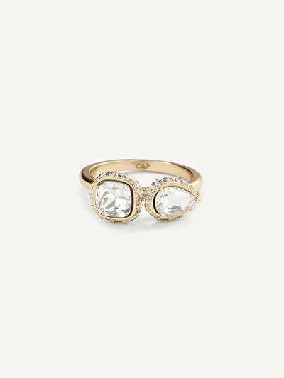 Gold ring with two clear gemstones on a white background
