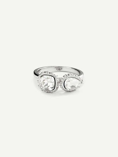 Silver ring with two clear gemstones on a white background