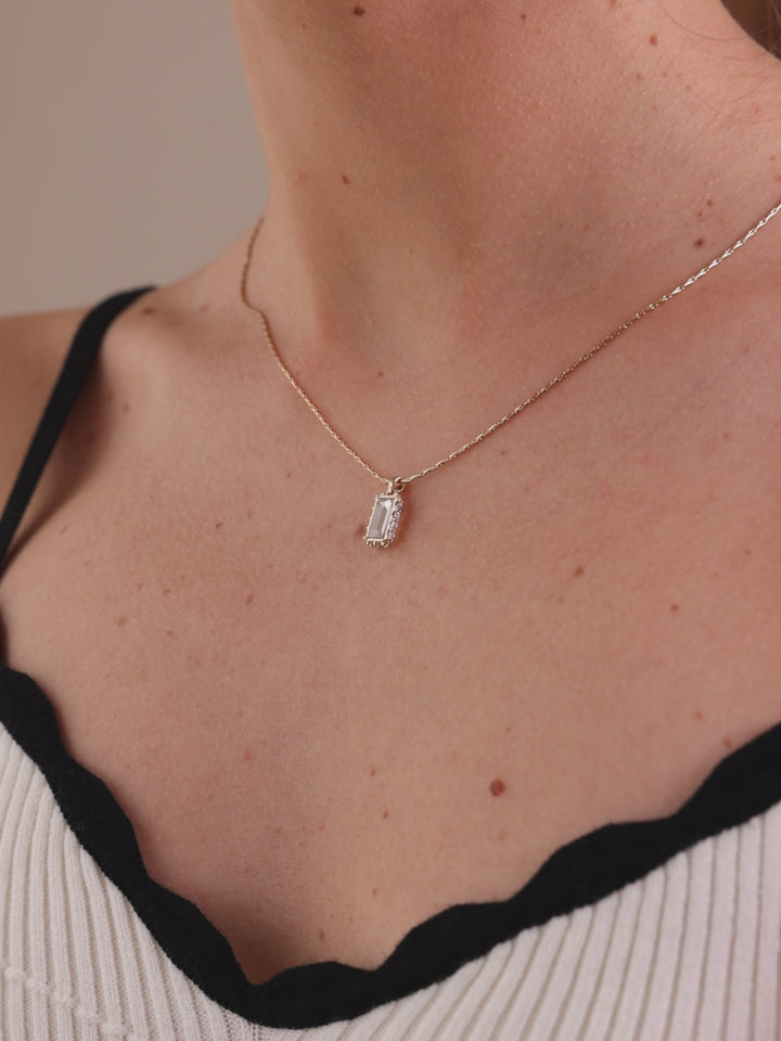 Gold necklace with a rectangular pendant 